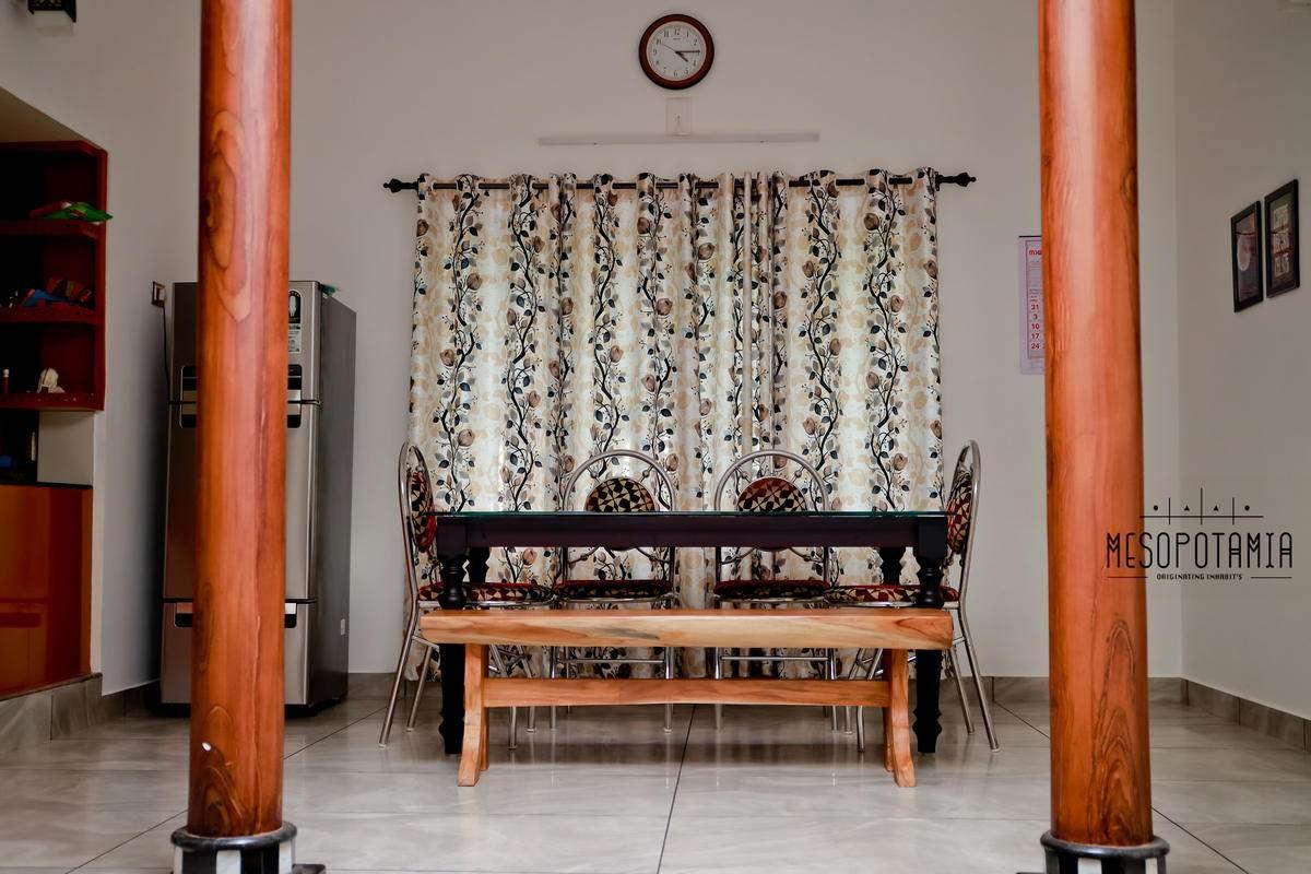 A dining room set between two columns rather than behind a wall