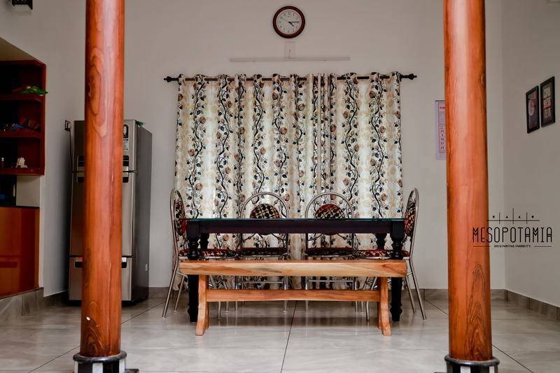 The dining room sits between two columns rather than behind a wall.