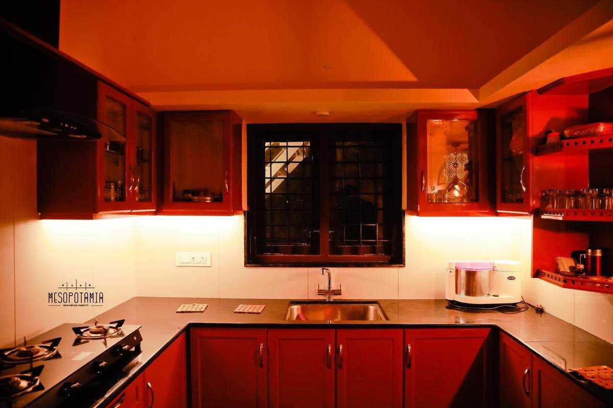 The working kitchen, in red lacquer against black stone.