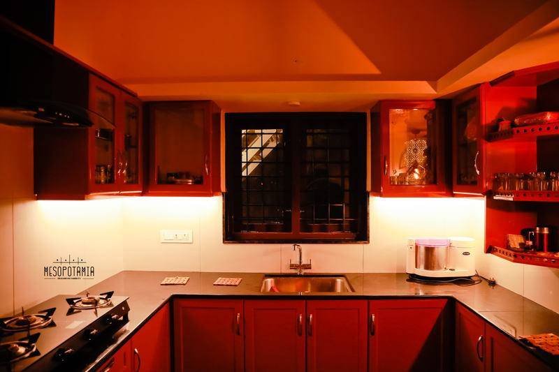 The working kitchen, in red lacquer against black stone.