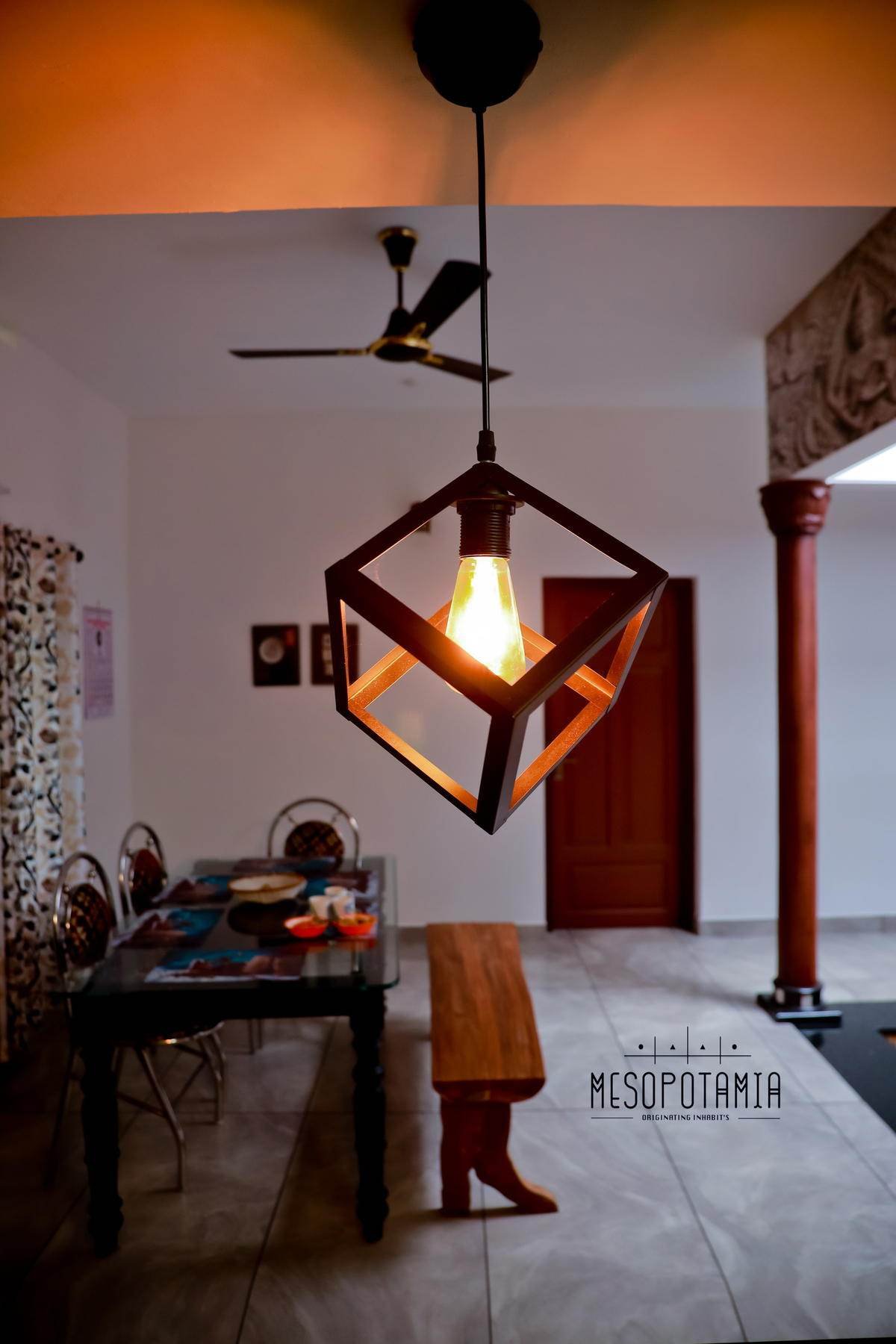 A hanging lamp over a timber table