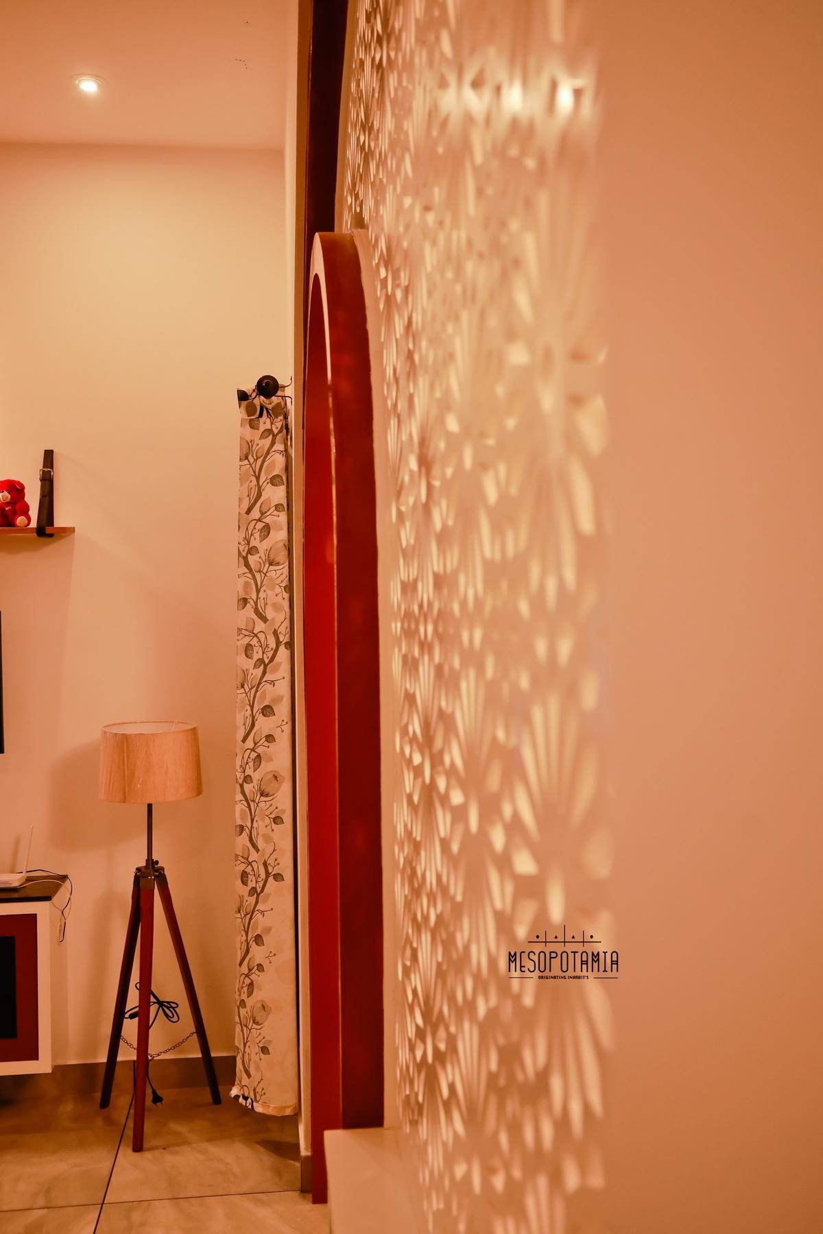 Light thrown across a wall through a cut screen