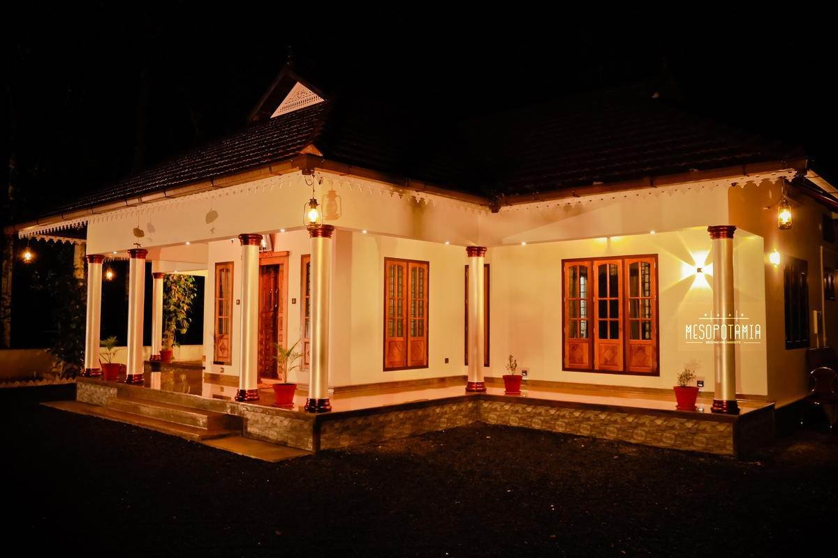 The long elevation at night. The roof line is deliberately lit.