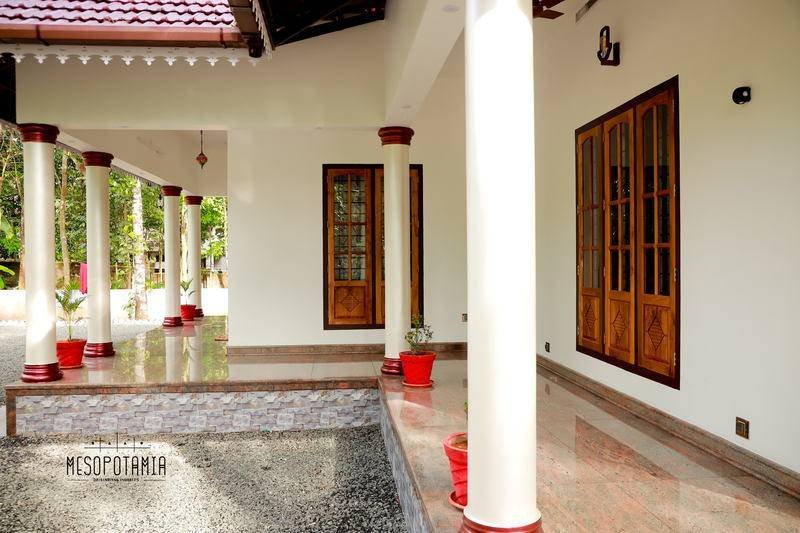 The verandah runs most of the way round. The roof, not the wall, does the shading.